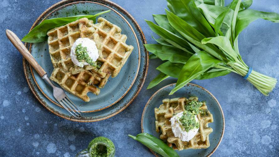 Bärlauchwaffeln mit Frischkäse-Topping auf einem Teller