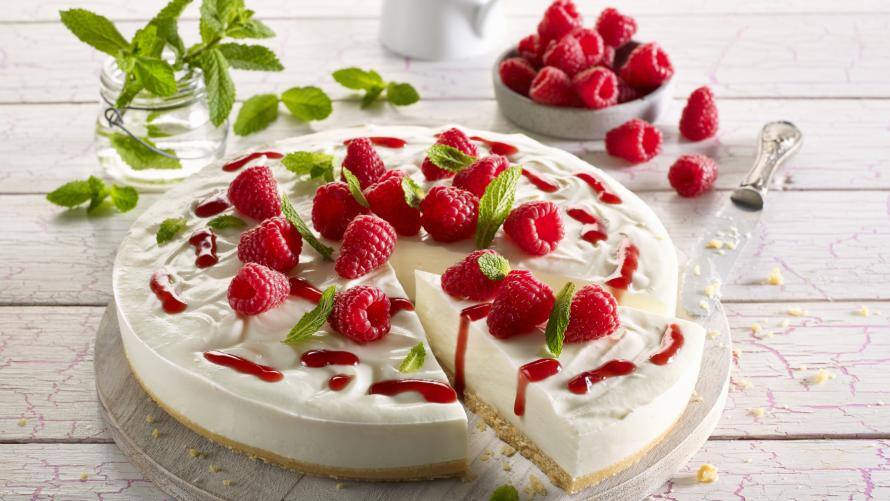 Frischkäsekuchen mit Himbeeren auf einer Tortenplatte