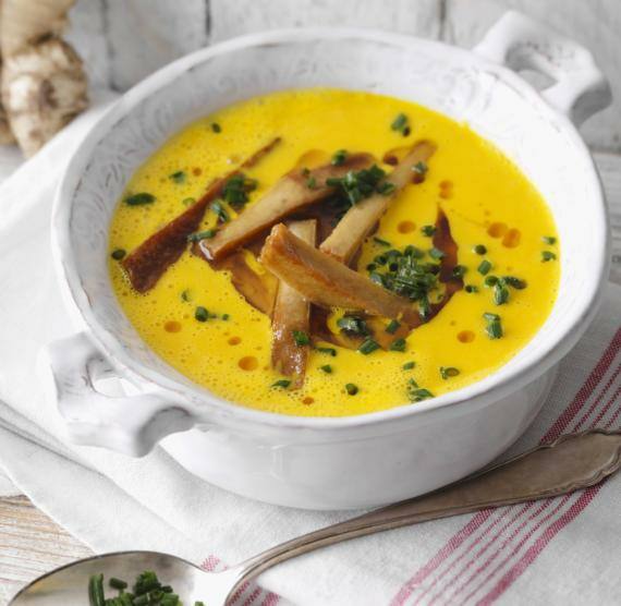 Weiße Schale mit Möhrensuppe und Tofu