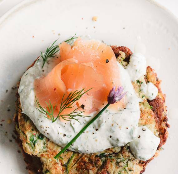 Zucchini-Puffer mit Lachs auf einem Teller