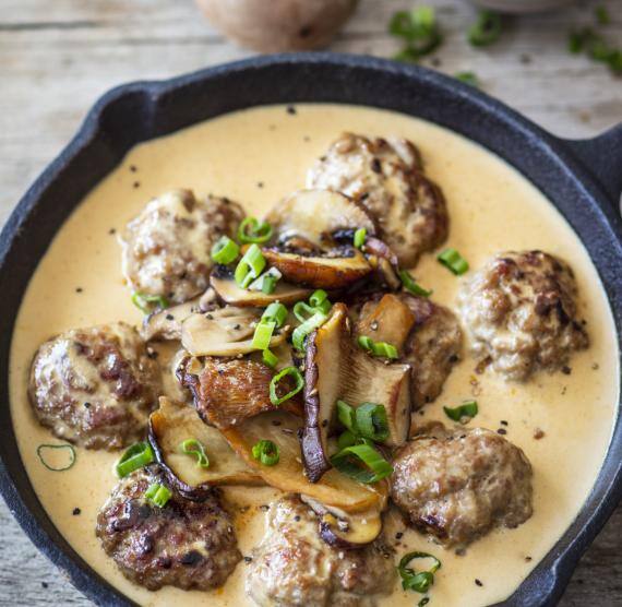 Pfanne mit Kötbullar mit Sauce und Pilzen