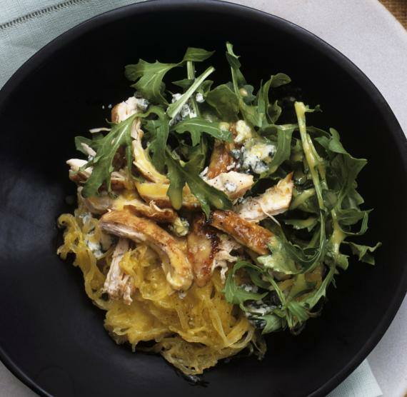 Zwei Teller mit Spaghettikürbis, Hähnchenstreifen, Gorgonzola und Rucola